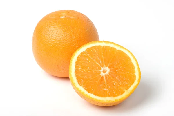 stock image Two oranges, one intersected to half. With clipping path