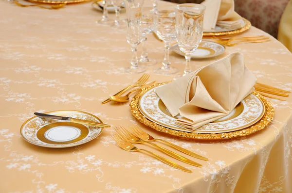 Golden cutlery with crystal glass — Stock Photo, Image