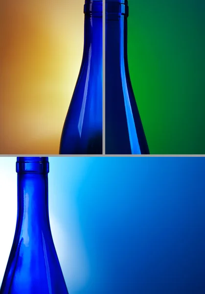 Blauwe wijnflessen op blauw groen geel backgrond — Stockfoto