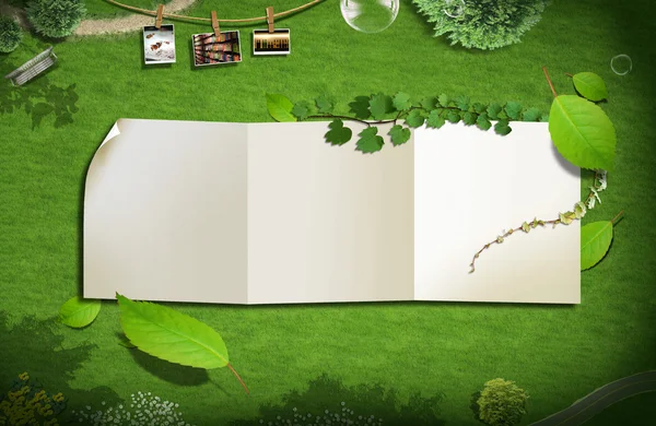 Blankt papper på grönt gräs. bakgrunden koncept — Stockfoto