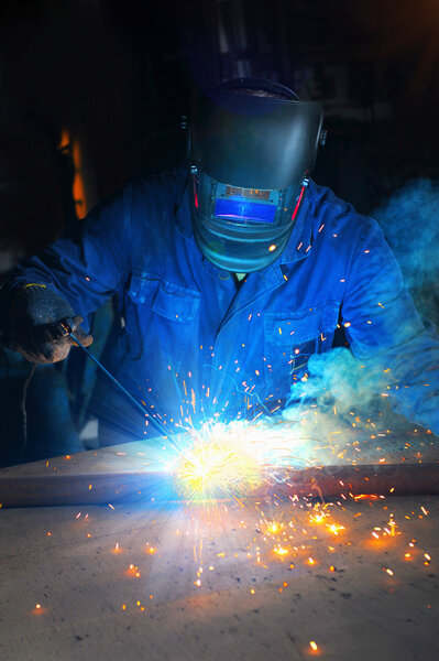 Welder man in a mask doing the work