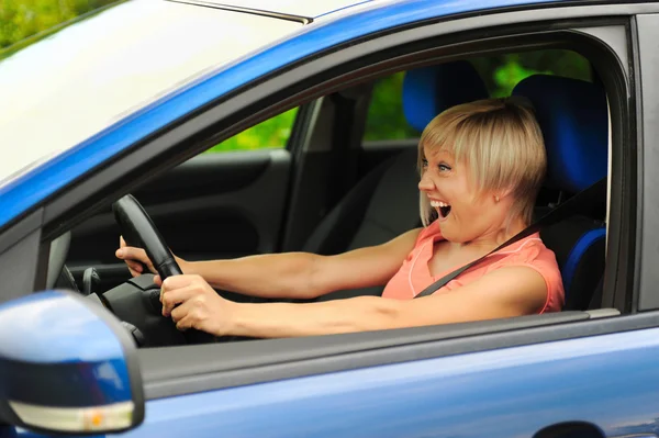 stock image Smiling young woman in the car