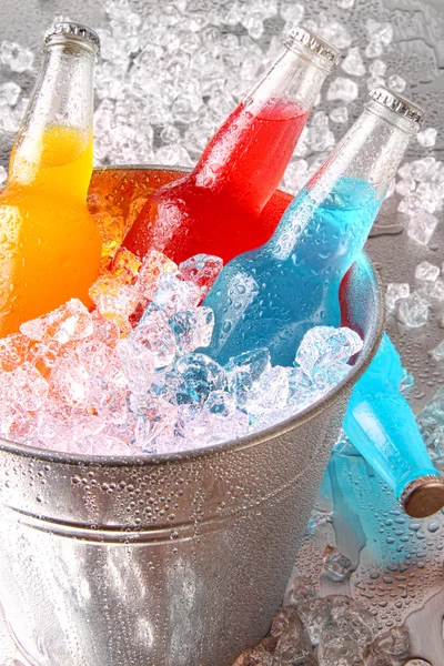 Bottles of cooler drinks with ice — Stock Photo, Image