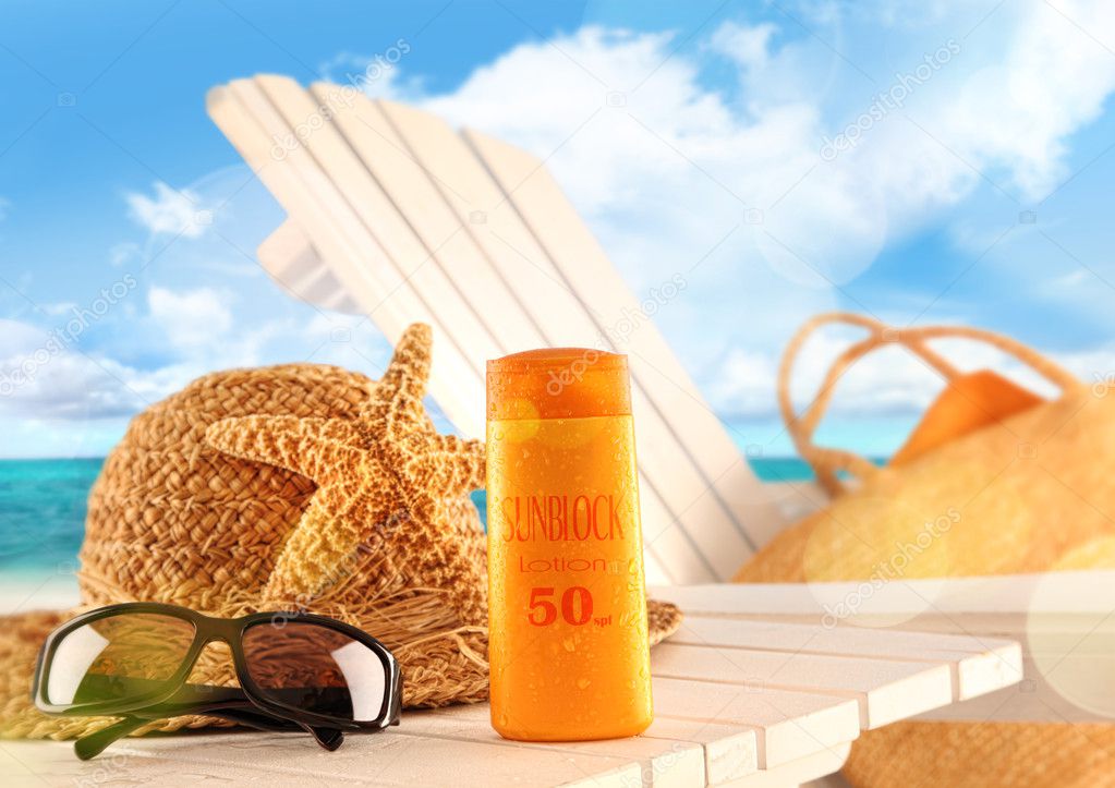 Sunblock lotion and beach items on table