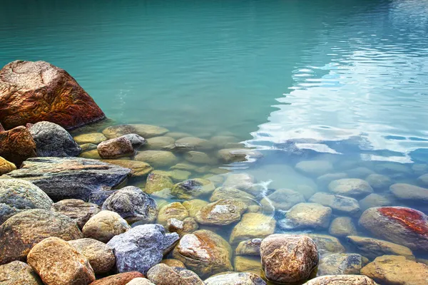 stock image Closeup of rocks in water at lake Louise