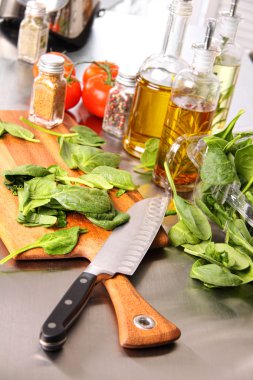 Preparing sinach leaves on cutting board clipart