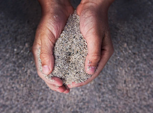 Hands holding sand — Stock Photo, Image