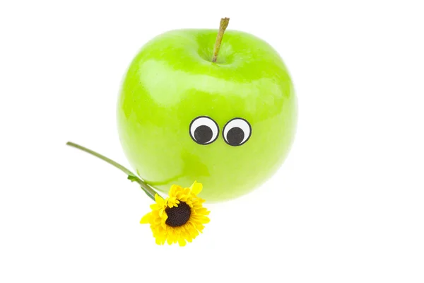 Manzana con ojos y una flor aislada en blanco —  Fotos de Stock
