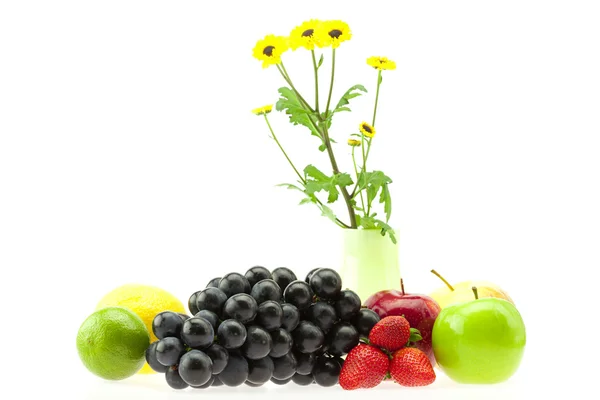Apple, strawberry, lemon, lime, grapes and flowers isolated on w — Stock Photo, Image