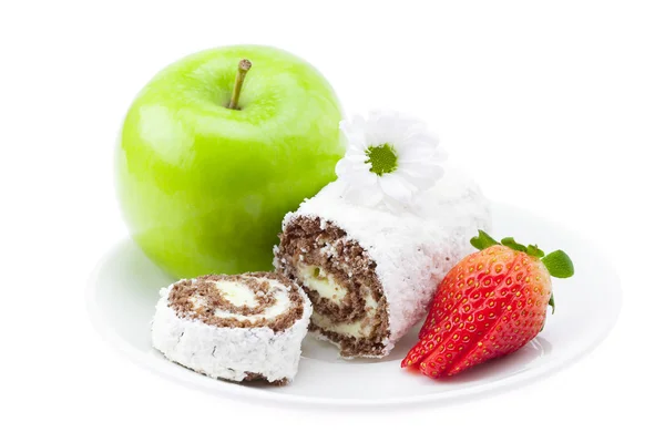 Cake roll, apple and strawberry on a plate isolated on white — Stock Photo, Image