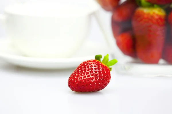 Tasse et fraise dans un bol en verre isolé sur blanc — Photo
