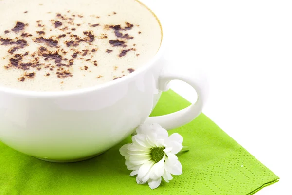 Cappuccino on the green cloth with flower isolated on white — Stock Photo, Image