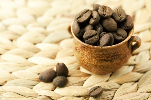Coffee beans lying in a small jug — Stock Photo, Image