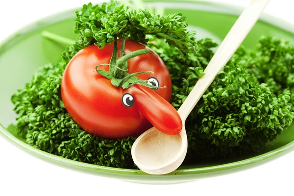 Tomato with a nose on the plate and the green isolated on white — Stock Photo, Image