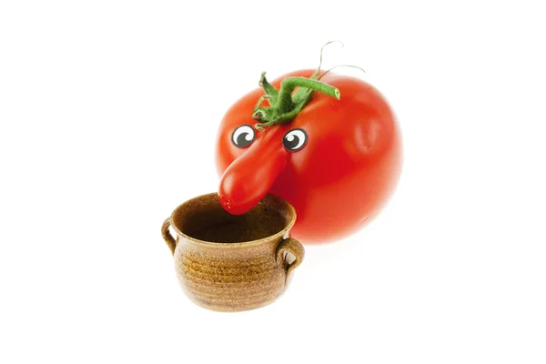 Tomato with a nose and a small jug isolated on white — Stock Photo, Image