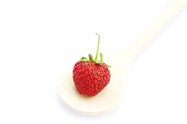 Strawberry in a wooden spoon isolated on white — Stock Photo, Image
