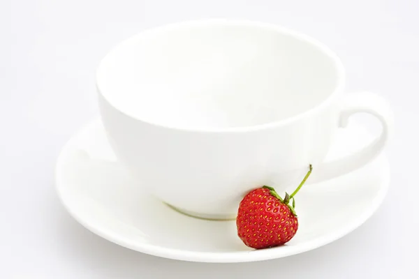 Cup saucer and strawberries isolated on white — Stock Photo, Image