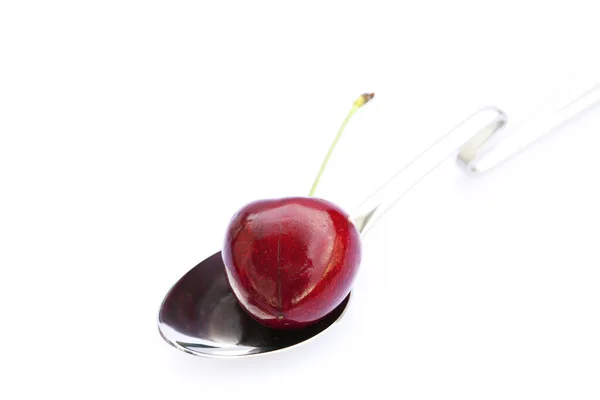 Cherry in a spoon isolated on white — Stock Photo, Image