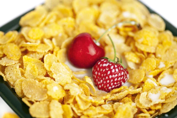 Background of bowl of cornflakes milk cherry and strawberry — Stock Photo, Image