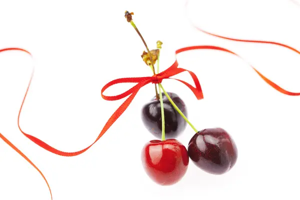 Cherry with ribbon isolated on white — Stock Photo, Image