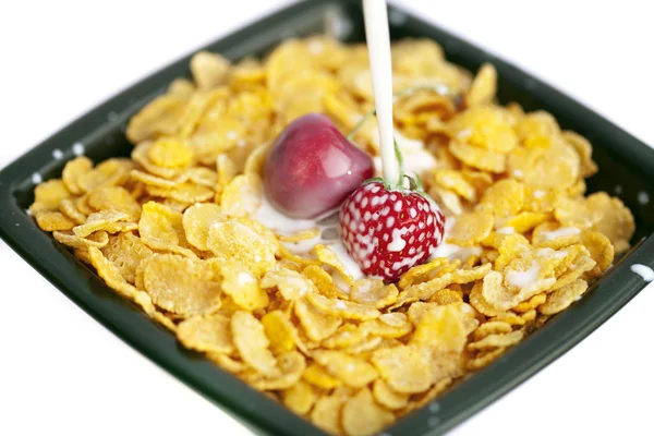 Bowl of cornflakes milk cherry and strawberry isolated on whi — Stock Photo, Image