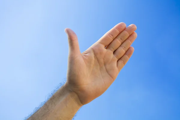 Hand against the blue sky — Stock Photo, Image