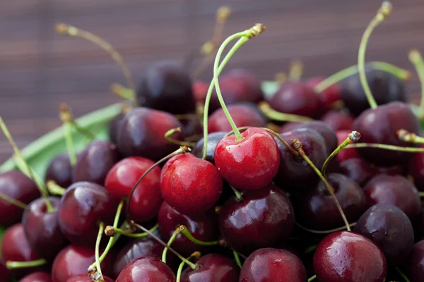 Cherry in plate on a bamboo mat — Stock Photo, Image