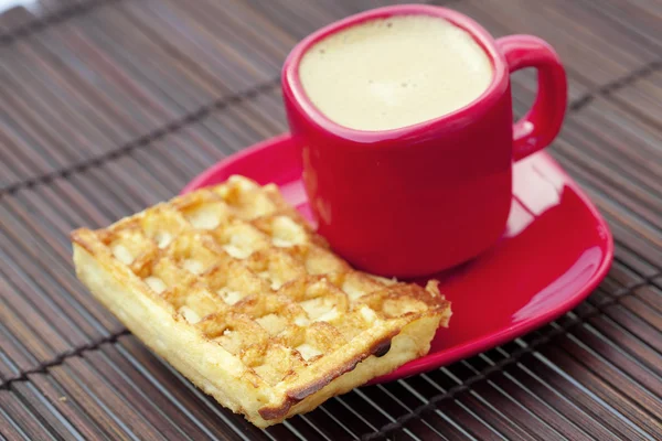 Cup of cappuccino wafers on a bamboo mat — Stock Photo, Image