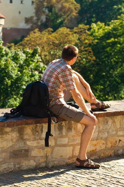 stock image Man sitting on a background of green foliage in Prague