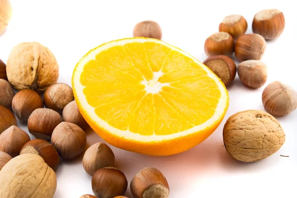 Orange and hazelnuts isolated on white — Stock Photo, Image