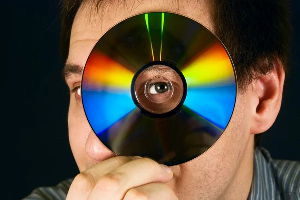 stock image Portrait of a man looking through a CD