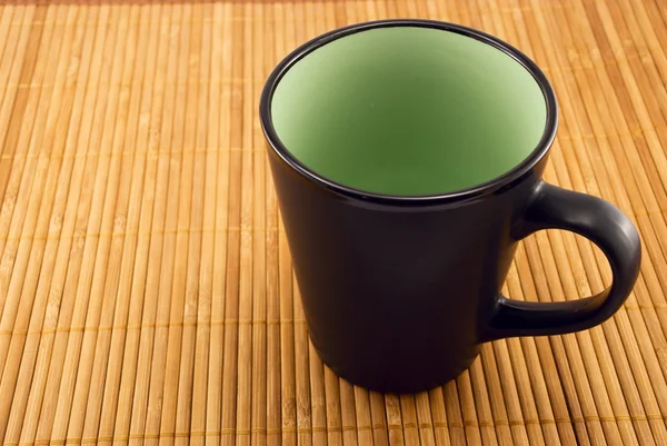 Cup on a bamboo mat — Stock Photo, Image