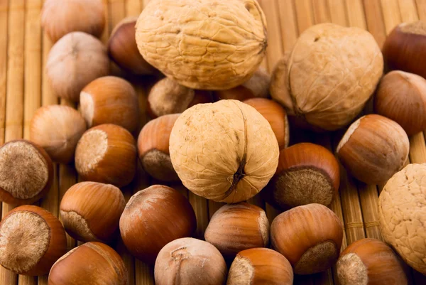 Nuts on a bamboo mat — Stock Photo, Image