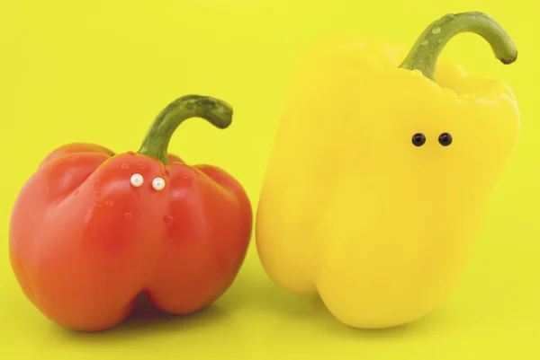 stock image Peppers with eyes on a yellow background