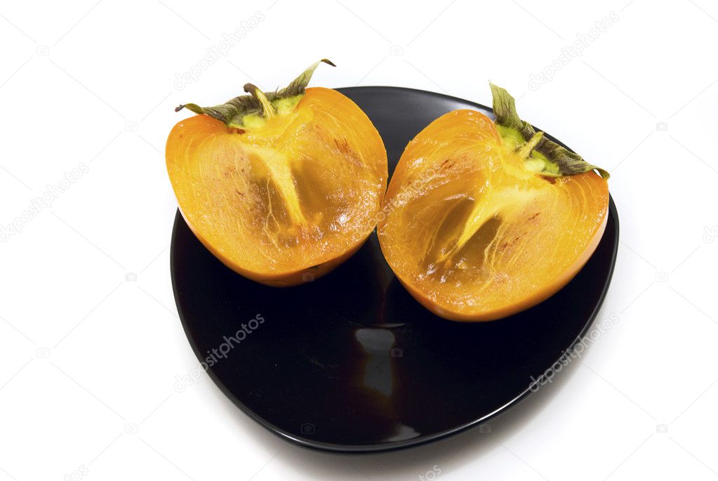 Persimmon on a plate isolated on white