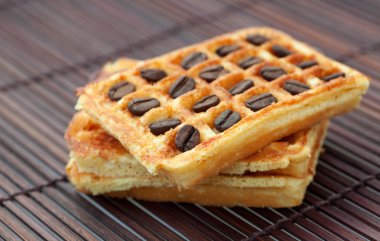 Wafers with coffee beans on a bamboo mat