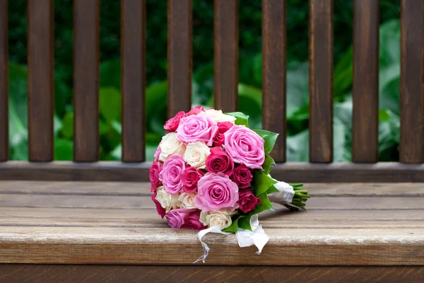 Beau bouquet nuptial couché sur les bancs en bois — Photo