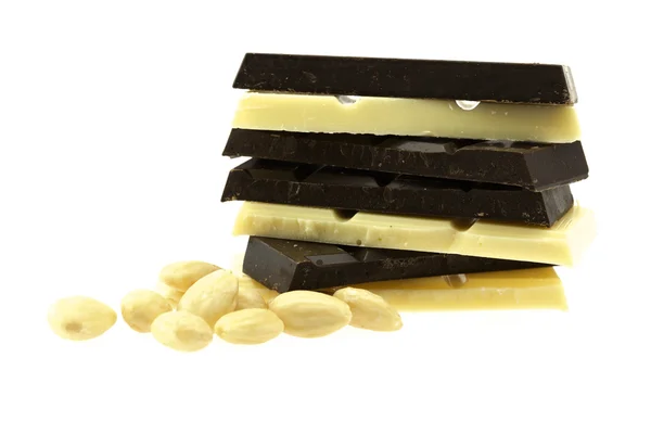 Dark and white chocolate and nuts are isolated on white — Stock Photo, Image