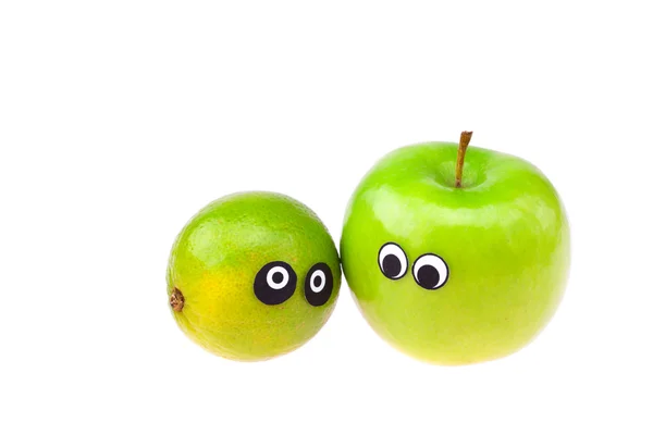Lima y manzana con ojos y rostros aislados en blanco — Foto de Stock
