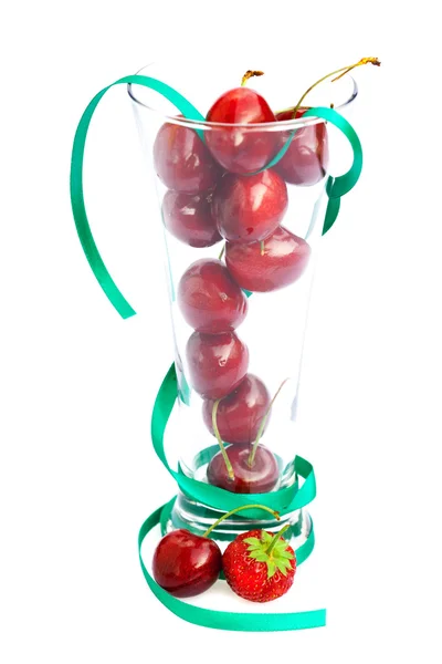 Cherry in a glass and ribbon isolated on white — Stockfoto