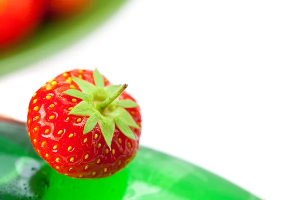 stock image Bottle of champagne with strawberries isolated on white