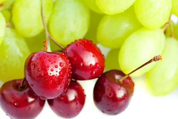 Grapes and cherries isolated on white — Stock Photo, Image
