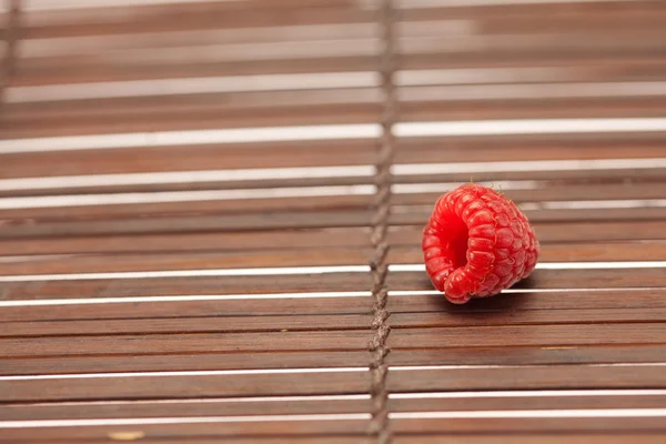 Raspberry on a bamboo mat — Stock Photo, Image