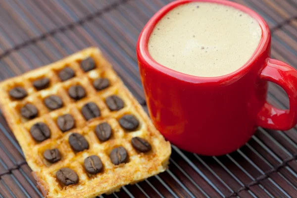 Coffee beans, waffles and cappuccino on a bamboo mat — Stock Photo, Image