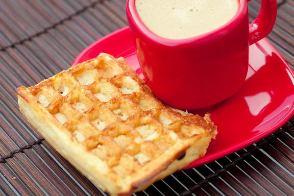 Waffles and cappuccino on a bamboo mat — Stock Photo, Image