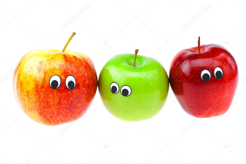 Apples with eyes and faces isolated on white