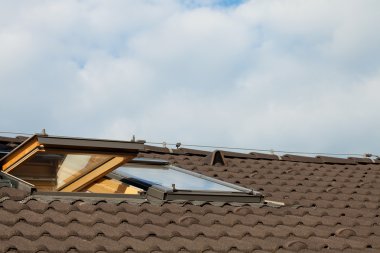 Tiled roof and dormer windows on the skyline clipart