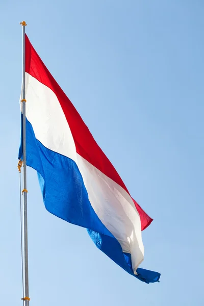 stock image Dutch flag against the blue sky