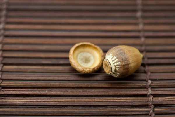 Acorn on a bamboo mat — Stock Photo, Image