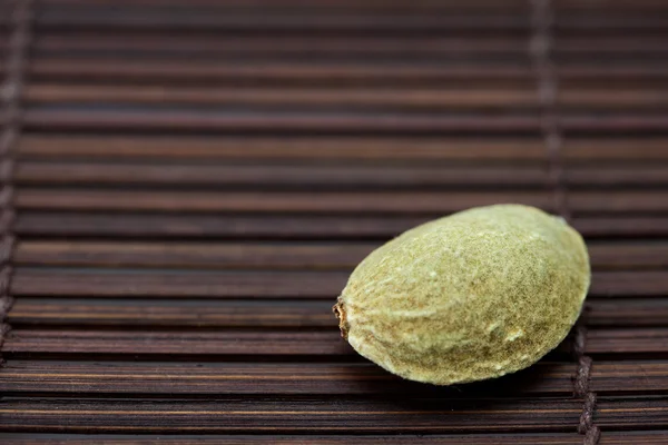 Almonds on a bamboo mat — Stock Photo, Image